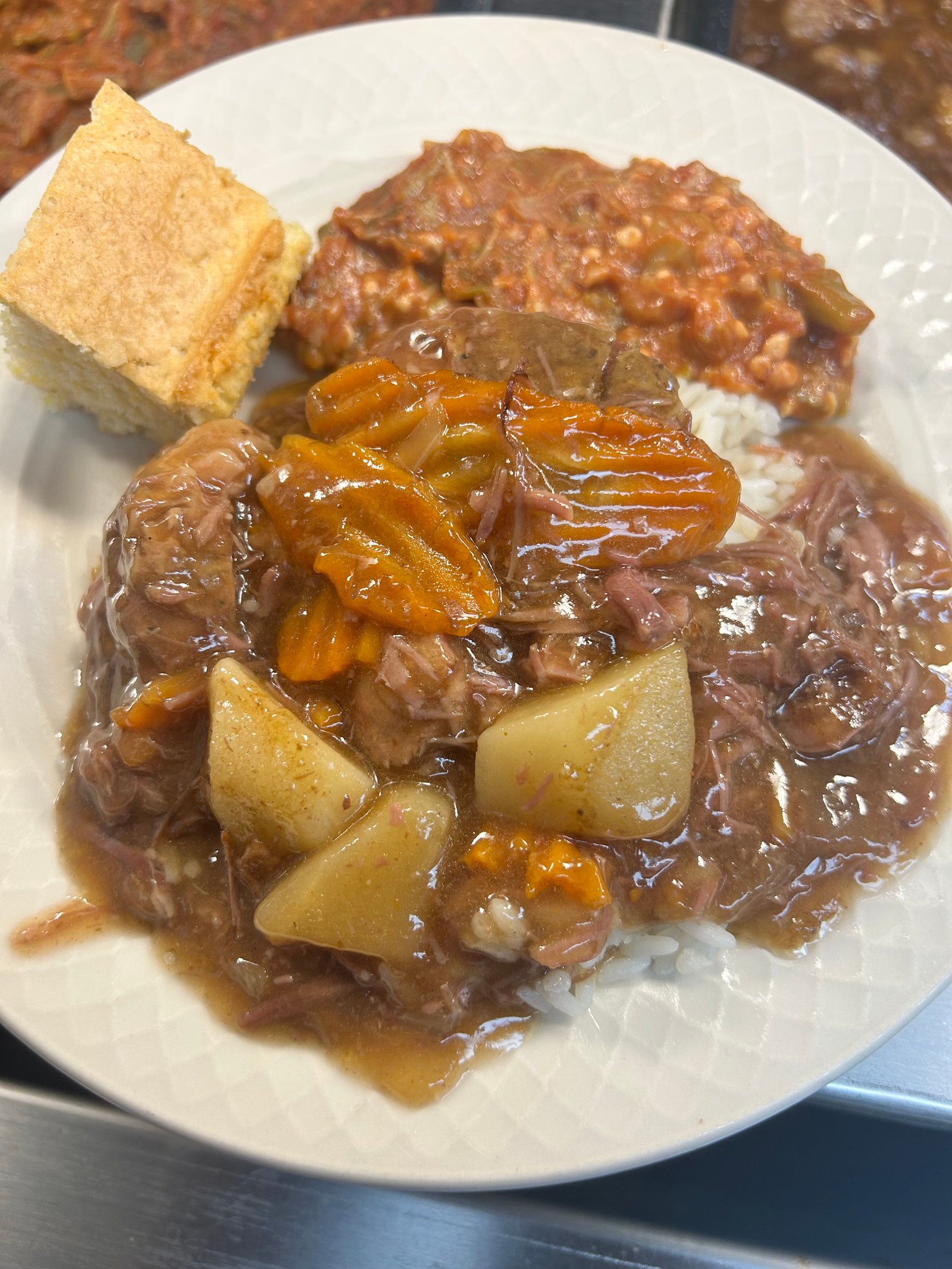 Beef stew over rice with cornbread